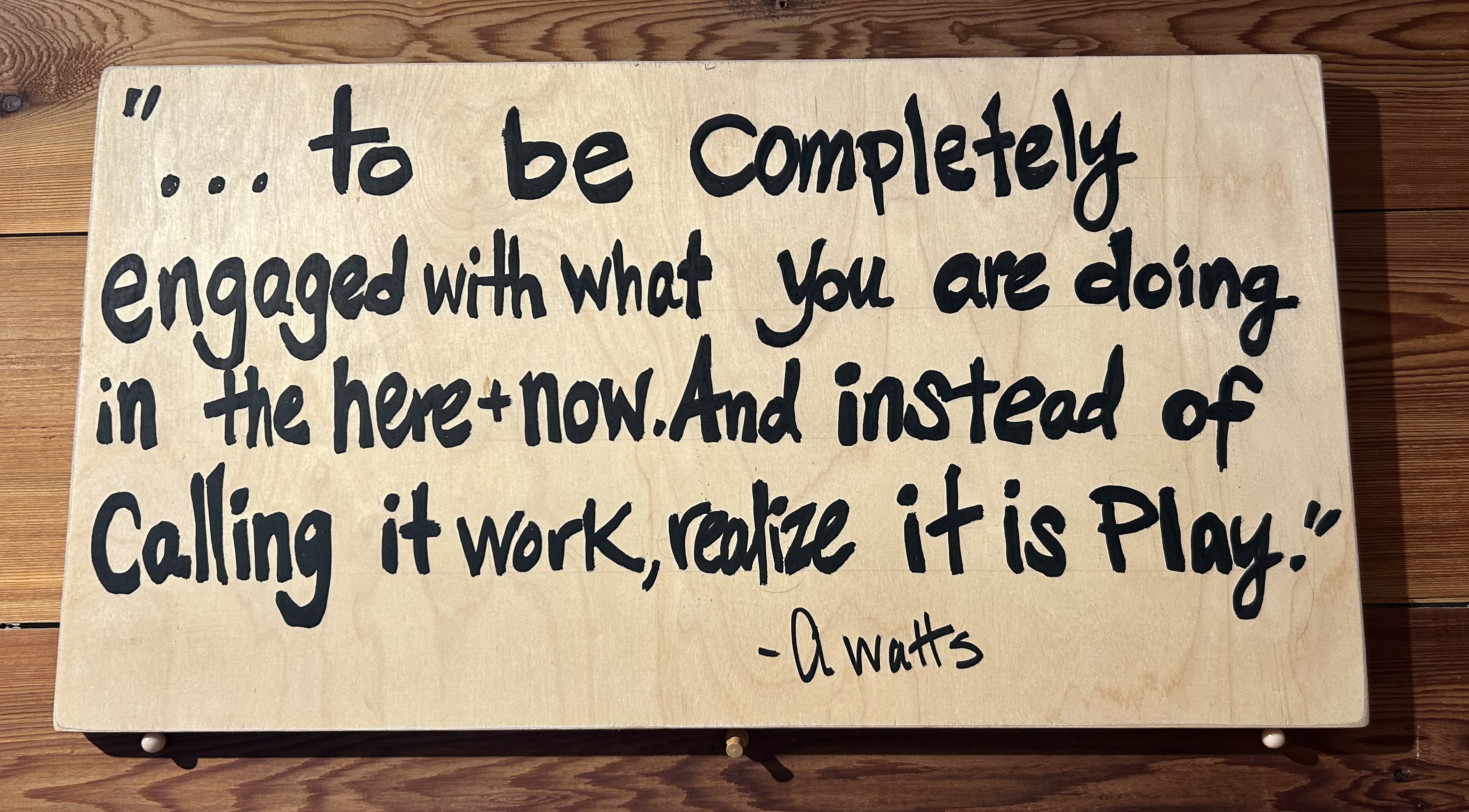 A hand-painted reminder to stay engaged with the present moment